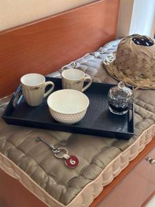 a tray with two coffee cups and a basket on a table at Papaioannou Aparts in Loutra Edipsou +40 photos