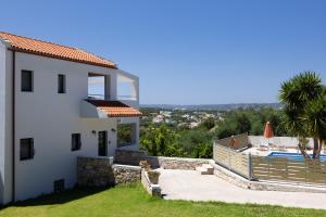 a villa with a view of a swimming pool at Villas Almyrida in Almyrida