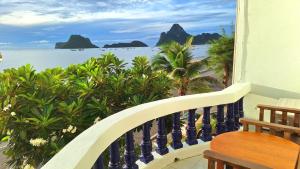 a balcony with a view of the beach and the ocean at Sunrise Guesthouse in Prachuap Khiri Khan