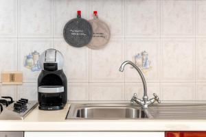 a kitchen counter with a sink and a mixer at Mare di Sicilia Apartments in Santa Maria Del Focallo +39 photos
