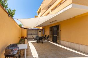 an outside view of a building with a patio at Mare di Sicilia Apartments in Santa Maria Del Focallo