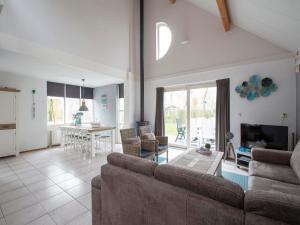 een woonkamer met een bank en een eetkamer bij Holiday Home by Beach in Ooghduyne in Julianadorp