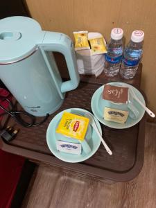 a table with two plates of food and a coffee maker at Anis View Chalet in Perhentian Island