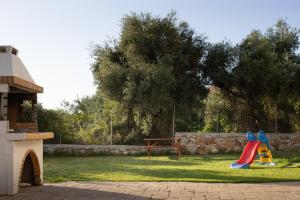 a playground with a slide and a bench in a yard at Villas Almyrida in Almyrida