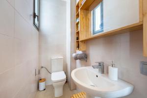 a bathroom with a white toilet and a sink at Casa Azahar playa Cabo De Gata 2 in Las Hortichuelas Bajas +19 photos