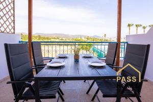 a table on a balcony with a view of the ocean at Aphrodite Apartment in Lachi