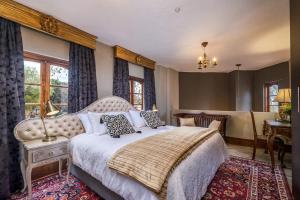 a bedroom with a large bed and a table at Ataraxia Place in Krugersdorp