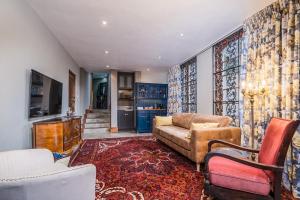 a living room with a couch and chairs at Ataraxia Place in Krugersdorp
