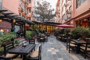 an empty patio of a restaurant with tables and chairs at Hotel Marshyangdi in Kathmandu
