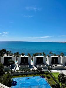 a view of a resort with a swimming pool and the ocean at Ocean View Apartment in Alicante