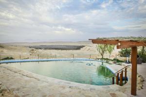 a swimming pool in the middle of the desert at Neot Semadar Eco Lodge in Naẖal Ya‘alon