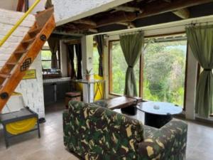 a living room with a couch and a table at Galunggung Basecamp Villa in Sukaratu