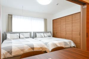 Postel nebo postele na pokoji v ubytování Evergreen hotel ichigaya