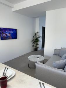 a living room with a couch and a table at Drop off in Ermoupoli