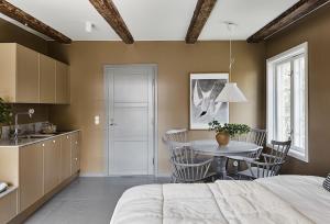 a kitchen and dining room with a bed and a table at Stay North - Matri House in Mathildedal
