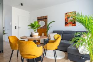 a living room with a couch and a table and chairs at Apartamenty Panorama 5! - Z widokiem, parkingiem, nowoczesne - wKarkonosze in Jelenia Góra +77 photos