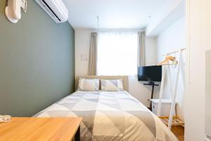 Postel nebo postele na pokoji v ubytování Evergreen hotel ichigaya