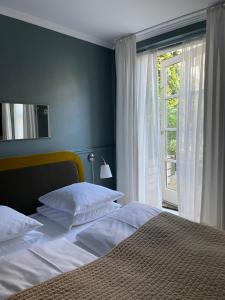 a bedroom with a large bed and a window at SOFS boutique hotel in Aarhus