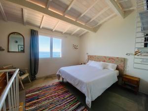 a bedroom with a bed and a large window at Zagara Blu in Latte +18 photos