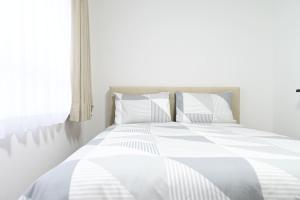 Postel nebo postele na pokoji v ubytování Evergreen hotel ichigaya