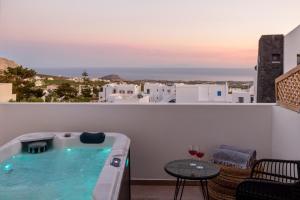 a hot tub on a balcony with a table at Elia Pyrgos in Pyrgos