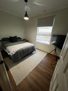 a bedroom with a bed and a flat screen tv at The Ryrie Loft in Geelong