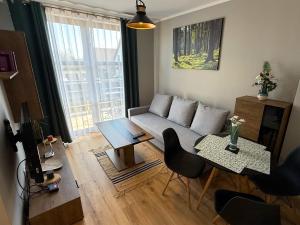 a living room with a couch and a table at Ośrodek Dalpol in Prażmowo