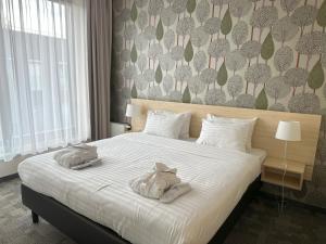Posteľ alebo postele v izbe v ubytovaní Golden Tulip Międzyzdroje Residence + 37 fotografií