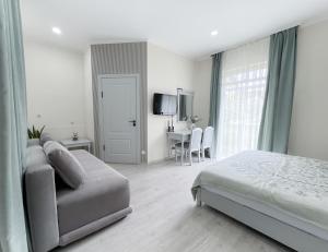a bedroom with a bed and a chair and a table at Raduga Orion villa in Chon-Sary-Oy +57 photos