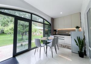 a dining room with a table and chairs in a kitchen at Raduga Orion villa in Chon-Sary-Oy