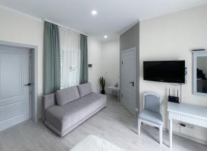 a living room with a couch and a tv at Raduga Orion villa in Chon-Sary-Oy
