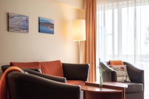 a living room with a couch and a table at Hotel Atlantic Juist in Juist