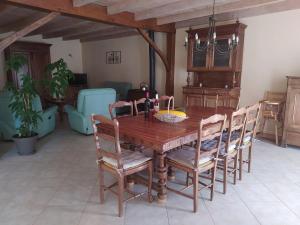 a dining room with a wooden table and chairs at Gîte spa privatif in La Roche-Chalais