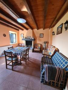 a living room with a table and chairs and a fireplace at Casa Rural Astorkigoikoa in Berreño