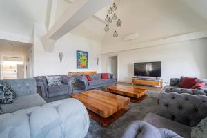 a living room with couches and a coffee table at ZOYA LUXURY RESIDENCE in Budapest
