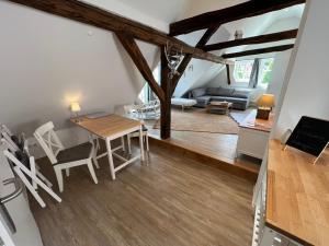 a dining room and living room with a table and chairs at Fachwerk Juwel in Melsungen