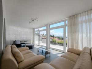 a living room with a couch and a large window at Elegant Apartments BOP in Portorož