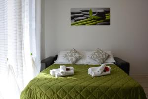 A bed or beds in a room at Green Residence