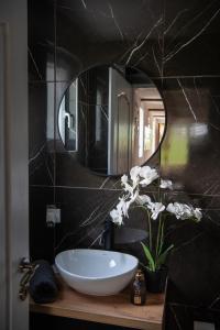 a bathroom with a white sink and a mirror at Carska oaza in Lukino Selo +19 photos