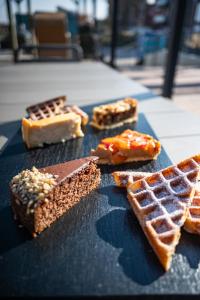 a table topped with waffles and waffle at Hotel Atlantic Juist in Juist