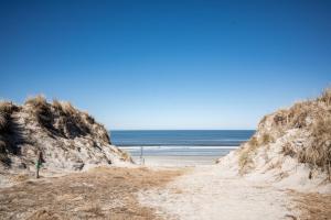a sandy beach with the ocean in the background at Hotel Atlantic Juist in Juist