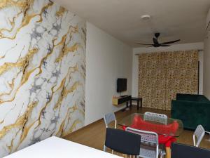 a living room with a marble wall at Maya Bay Residence Splashmania Gamuda Cove in Banting