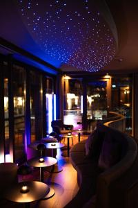 a room with a couch and tables in a building at Hotel Atlantic Juist in Juist