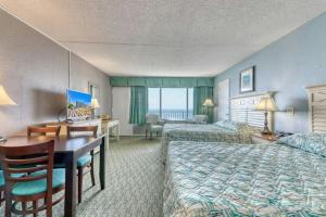 a hotel room with two beds and a desk at Blockade Runner in Myrtle Beach +66 photos