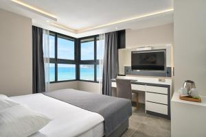 Postel nebo postele na pokoji v ubytování Kaila Krizantem Hotel