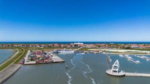 an aerial view of a marina with boats in the water at Hotel Atlantic Juist in Juist