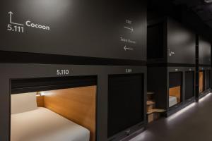 a display of a room with a bed and mirrors at Zedwell Capsule Hotel Piccadilly Circus in London