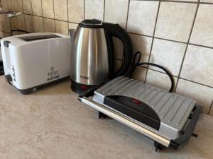 a toaster sitting next to a toaster and a blender at Areti in Fanari