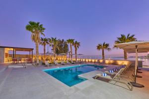 a pool with chairs and umbrellas on a building at City Express by Marriott La Paz in La Paz