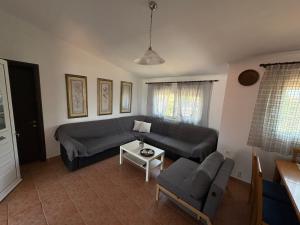 a living room with a couch and a table at Areti in Fanari
